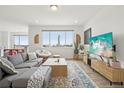 Bright living room with large windows, modern furnishings, and hardwood floors at 545 High Point Dr, Longmont, CO 80504