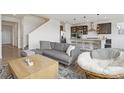 Cozy living room with a view of the modern kitchen and staircase at 545 High Point Dr, Longmont, CO 80504
