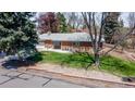Well-kept brick home featuring a charming front yard, mature trees, and a two-car garage at 12375 W 19Th Pl, Lakewood, CO 80215
