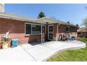 Inviting front entrance with brick facade, covered porch, and decorative security door at 12375 W 19Th Pl, Lakewood, CO 80215