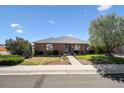 Lovely brick home featuring lush landscaping and a well-manicured lawn under a bright blue sky at 640 N 15Th Ave, Brighton, CO 80601