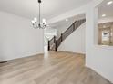 Spacious living area featuring a staircase, wood flooring, and contemporary design at 24768 E 40Th Ave, Aurora, CO 80019