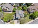 Overhead view of a home with a well-maintained roof, surrounded by mature trees and green yards at 4875 E 117Th Dr, Thornton, CO 80233