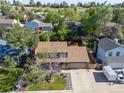 Aerial view of a neatly landscaped home with a large backyard and a long driveway, nestled in a quiet neighborhood at 3238 W 11Th Avenue Pl, Broomfield, CO 80020