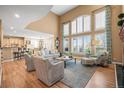 Bright and spacious living room showcasing hardwood floors, high ceilings, and large windows at 7035 S Picadilly St, Aurora, CO 80016