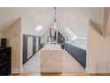 Modern kitchen with a large island with a quartz countertop, skylights, and lots of cabinets for storage at 1165 N Pennsylvania St # 3B, Denver, CO 80203