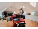 Open-concept living room featuring a stone fireplace and elegant spiral staircase, perfect for modern living at 1165 N Pennsylvania St # 3B, Denver, CO 80203