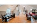 Open floor plan offers seamless flow, with dining area and living space featuring hardwood floors and a unique spiral staircase at 1165 N Pennsylvania St # 3B, Denver, CO 80203