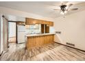 Bright kitchen with wooden cabinets and a ceiling fan at 9477 W 89Th Cir, Broomfield, CO 80021