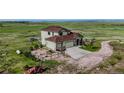 Aerial view of a home with a circular driveway and a sprawling green landscape at 28340 Dylon Cir, Elizabeth, CO 80107