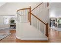 View of a curved staircase with white spindles and wooden handrail at 6858 Johnson St, Arvada, CO 80004