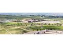 Aerial community view shows a high school, a sports field and the surrounding area at 22962 Briar Leaf Ave, Parker, CO 80138