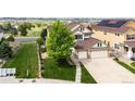 Aerial view of home showing three-car garage, landscaping and neighborhood at 22962 Briar Leaf Ave, Parker, CO 80138