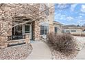 Covered porch entrance to condo with table and chairs at 431 Black Feather Loop # 804, Castle Rock, CO 80104