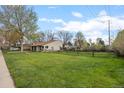 Expansive grassy yard surrounded by a wooden fence, offering ample outdoor space at 1000 Zang St, Golden, CO 80401
