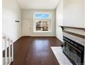 Bright living room with hardwood floors and a fireplace at 1885 S Quebec Way # H27, Denver, CO 80231