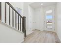 Bright entryway with modern front door and light flooring at 9208 Truckee Ct, Commerce City, CO 80022