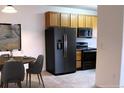 Kitchen with stainless steel appliances, including a refrigerator, range, microwave and dining table with chairs at 3220 Boulder Cir # 103, Broomfield, CO 80023