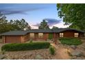 Beautiful ranch home features a well-manicured yard and a colorful green front door at 19 Rock Ln, Castle Rock, CO 80104