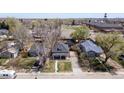 Aerial view showcases this home's location in a quiet neighborhood with mature trees and nearby amenities at 5612 Ammons St, Arvada, CO 80002