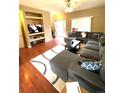 Comfortable living room with a large sectional sofa, plush rug, and built-in shelving at 19246 E Idaho Pl # 102, Aurora, CO 80017