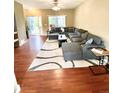 Spacious living room with a large sectional sofa, stylish rug, and hardwood floors at 19246 E Idaho Pl # 102, Aurora, CO 80017