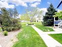 Green common area with trees and sidewalks, adjacent to residences at 19246 E Idaho Pl # 102, Aurora, CO 80017