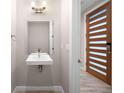 Small modern bathroom with floating sink and a mirror at 4455 Tennyson St, Denver, CO 80212