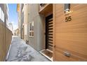 Modern townhome entry with wood siding and sleek door at 4455 Tennyson St, Denver, CO 80212