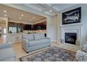 Open living room with a view into the kitchen and a cozy fireplace at 23636 E Del Norte Pl, Aurora, CO 80016