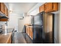 This well-lit kitchen includes wooden cabinets, smooth countertops, and newer appliances at 1625 Larimer St # 605, Denver, CO 80202
