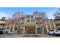Exterior shot of building with multiple stories and front entrance, landscaping with trees, and multiple balconies at 1300 S Parker Rd # 9, Denver, CO 80231