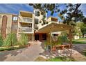 Exterior shot of building with multiple stories and front entrance, landscaping with green plants, and multiple balconies at 1300 S Parker Rd # 9, Denver, CO 80231