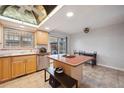 Bright kitchen featuring stainless steel appliances, wooden cabinetry and a functional center island at 9019 E Oxford Dr, Denver, CO 80237