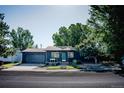 Charming home with attached garage, well manicured lawn and landscaping in the front yard at 332 Maple Dr, Frederick, CO 80530