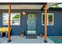 Inviting front porch with wood columns, bench seating, plants, and a stylish wreath at 332 Maple Dr, Frederick, CO 80530