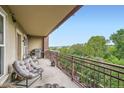 Relax on this inviting balcony with a grill and seating area overlooking lush greenery at 2240 N Clay St # 406, Denver, CO 80211