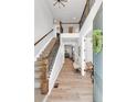 Inviting entryway with hardwood floors, a staircase with iron railings, and a view to other rooms at 821 Boulder Peak Ave, Erie, CO 80516