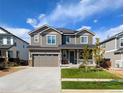 Charming two-story home with a well-manicured lawn and a two-car garage on a sunny day at 821 Boulder Peak Ave, Erie, CO 80516