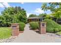 Welcoming entrance with brick pillars, well-manicured bushes, and a stone pathway at 2520 Eldridge Cir, Golden, CO 80401