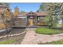 Charming front exterior with brick and wood design, complemented by a unique stone pathway at 916 W Alder St, Louisville, CO 80027