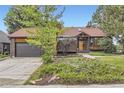 Charming front exterior showcasing brick design, a garage, and beautifully landscaped yard at 916 W Alder St, Louisville, CO 80027