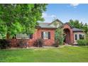 Charming red brick home with manicured lawn and a picturesque arched entryway, creating a welcoming curb appeal at 5926 S Elkhart Ct, Centennial, CO 80016