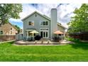 Spacious backyard with a patio area, perfect for entertaining, featuring outdoor furniture and a lush green lawn at 1387 Mcintosh Ave, Broomfield, CO 80020