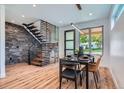 Elegant dining area featuring a unique staircase design, stylish decor, and plenty of natural light at 2599 S Cherokee St, Denver, CO 80223