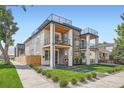 Contemporary home boasts multi-level outdoor decks and modern design with stone accents and manicured landscaping at 2599 S Cherokee St, Denver, CO 80223