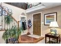 Inviting foyer with hardwood floors, a wooden staircase, and a stylish front door creating a warm entry at 4907 Fenwood Dr, Highlands Ranch, CO 80130