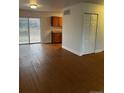 Open-concept space featuring laminate flooring and sliding glass door at 6392 S Hill St, Littleton, CO 80120