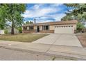 Single-story home featuring a neutral paint scheme, brick accents, and an attached two-car garage at 4559 Ashfield Dr, Boulder, CO 80301