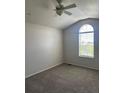 Neutral bedroom features an arched window, plush carpeting, and ample natural light at 16366 E Fremont Ave # 11, Aurora, CO 80016